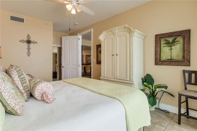 bedroom with light tile patterned floors, a ceiling fan, visible vents, and baseboards