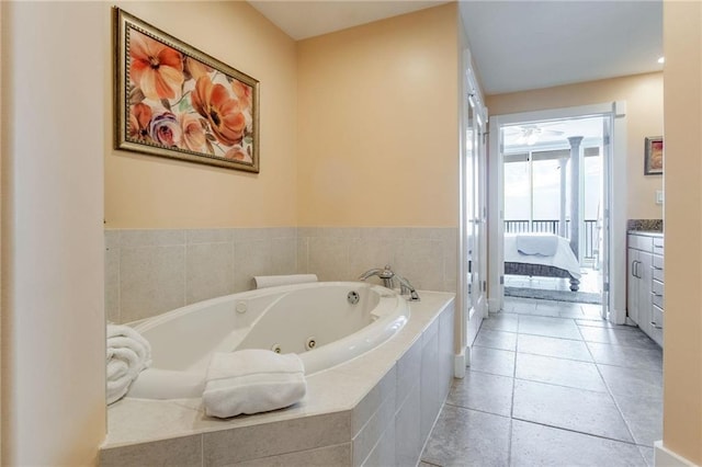 bathroom with a whirlpool tub, vanity, and tile patterned floors