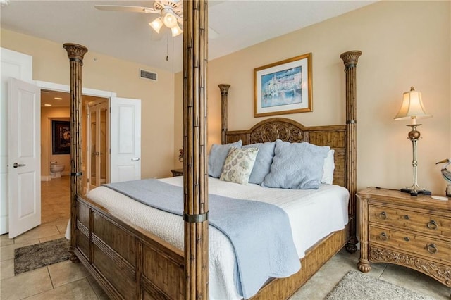 bedroom with a ceiling fan, visible vents, ensuite bath, and light tile patterned floors