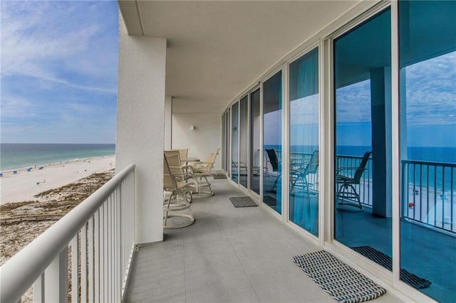 balcony featuring a water view and a view of the beach