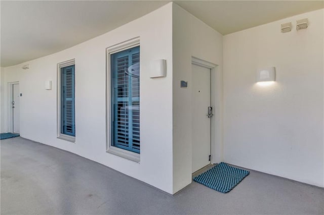 entrance to property with stucco siding