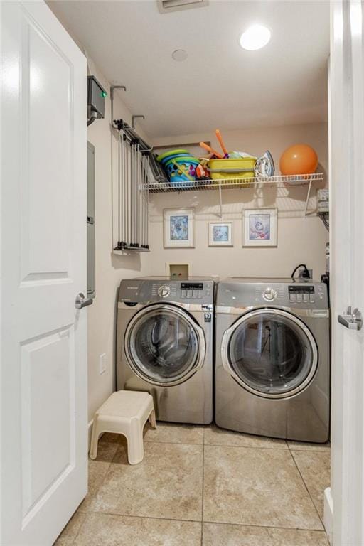 clothes washing area featuring laundry area, tile patterned flooring, and independent washer and dryer