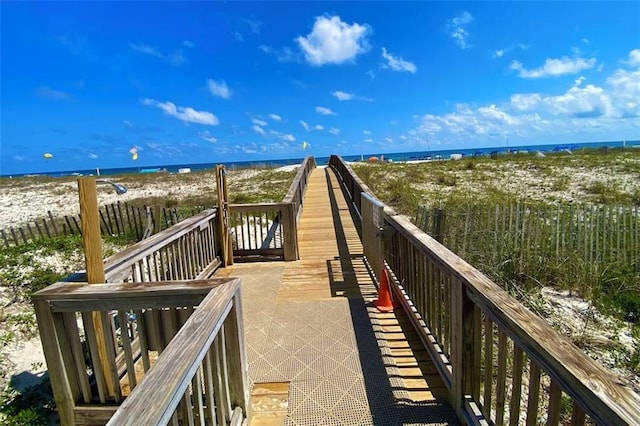 view of property's community with a water view and a view of the beach