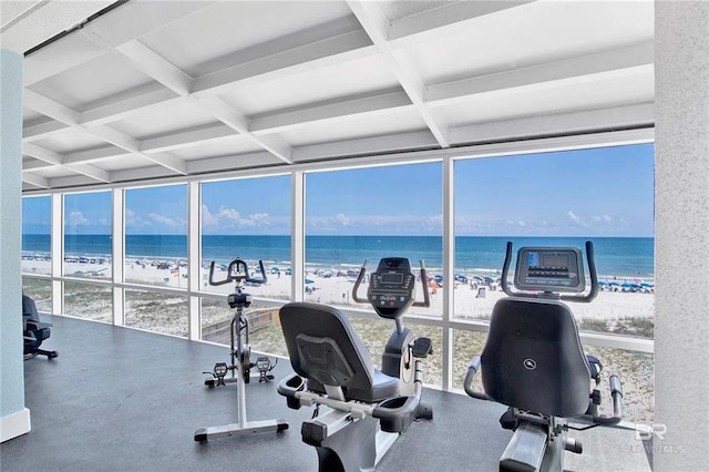 workout area with expansive windows, coffered ceiling, and a water view