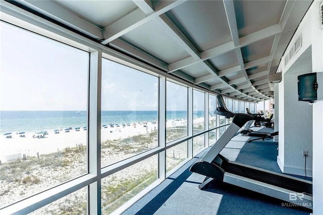 interior space featuring a beach view, coffered ceiling, and beam ceiling