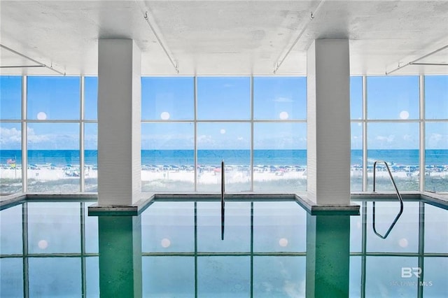 indoor pool featuring a water view