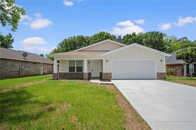 17126 Sugar Loop, Foley, AL 36535 - view of front of home with brick siding, a garage, a front lawn, concrete driveway, and board and batten siding