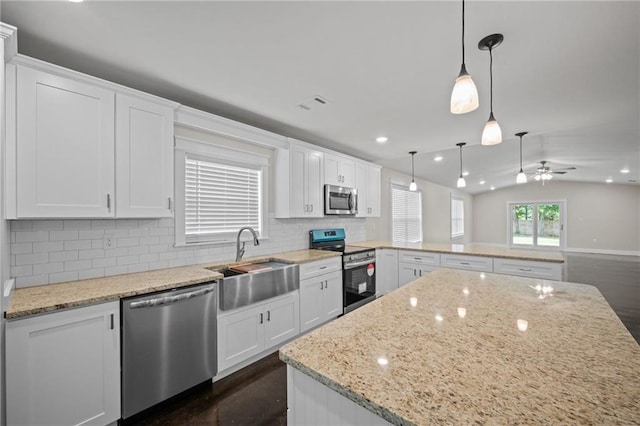 17126 Sugar Loop, Foley, AL 36535 - kitchen with stainless steel appliances, a sink, a peninsula, backsplash, and white cabinetry