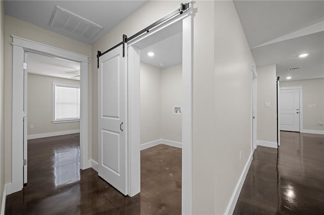 17126 Sugar Loop, Foley, AL 36535 - hallway featuring a barn door, concrete floors, baseboards, and recessed lighting