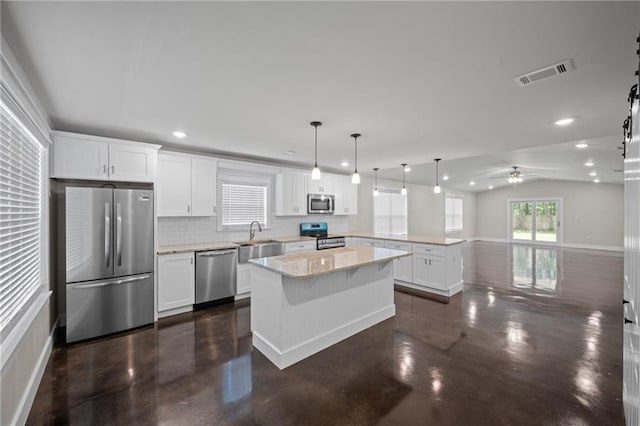 17126 Sugar Loop, Foley, AL 36535 - kitchen with appliances with stainless steel finishes, concrete floors, a peninsula, a sink, and recessed lighting