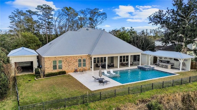 back of property with a fenced in pool, a patio area, a yard, and an outbuilding