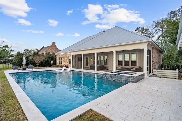 view of swimming pool with an in ground hot tub and a patio