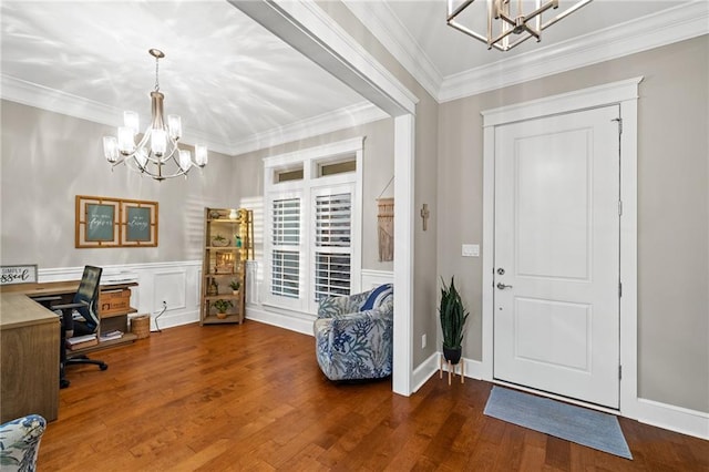 entrance foyer featuring ornamental molding, dark hardwood / wood-style flooring, and a chandelier