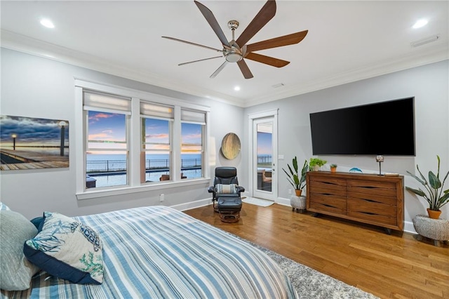 bedroom featuring ceiling fan, hardwood / wood-style flooring, and crown molding