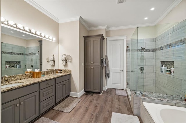 bathroom with crown molding, vanity, separate shower and tub, and hardwood / wood-style floors