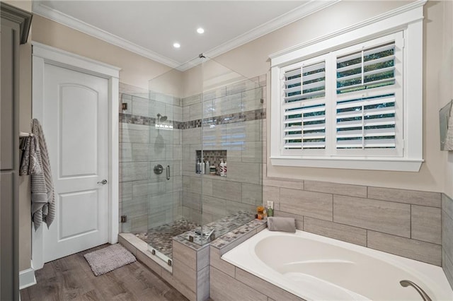 bathroom featuring ornamental molding, independent shower and bath, and hardwood / wood-style flooring