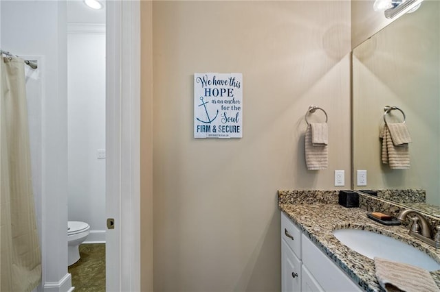 bathroom with vanity, toilet, and walk in shower