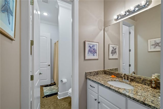 bathroom with ornamental molding, vanity, toilet, and tile patterned flooring