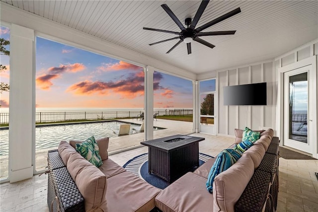 view of patio with an outdoor living space, a water view, and ceiling fan