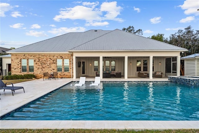 view of swimming pool with french doors and a patio area