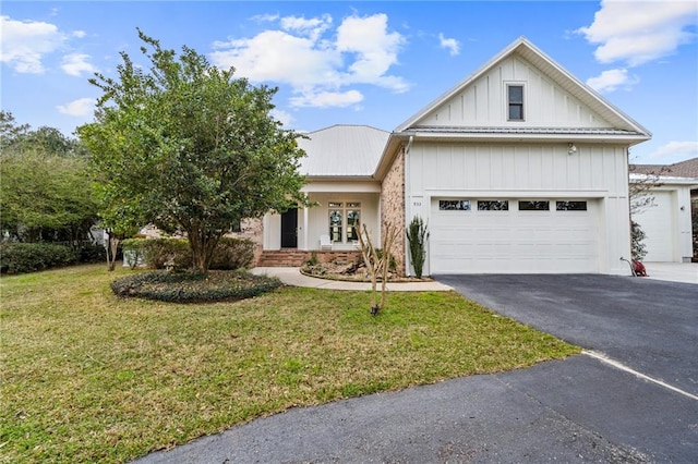 view of front of home with a front yard and a garage