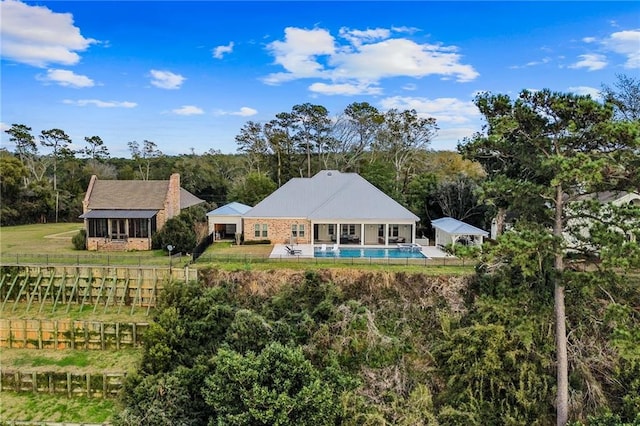 back of property featuring a fenced in pool