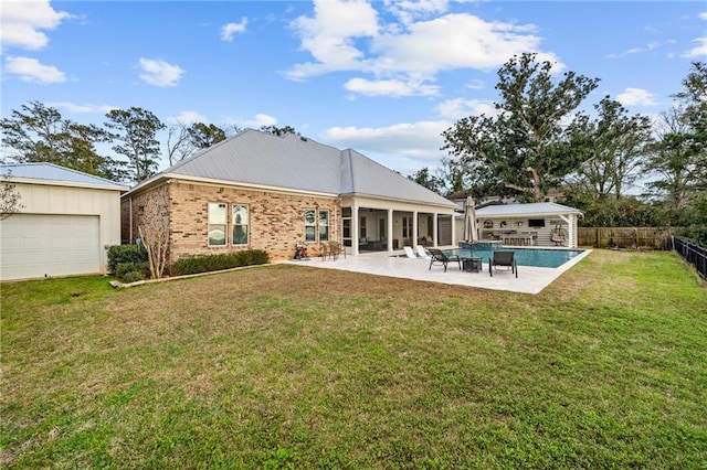 rear view of property featuring a yard and a patio area