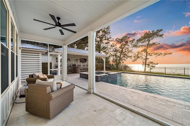 exterior space featuring a water view, ceiling fan, a patio, and an outdoor hangout area