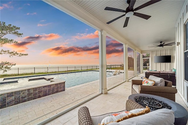 view of patio with a water view, ceiling fan, a fenced in pool, and an outdoor hangout area