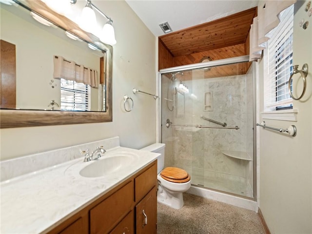 bathroom with walk in shower, vanity, and toilet