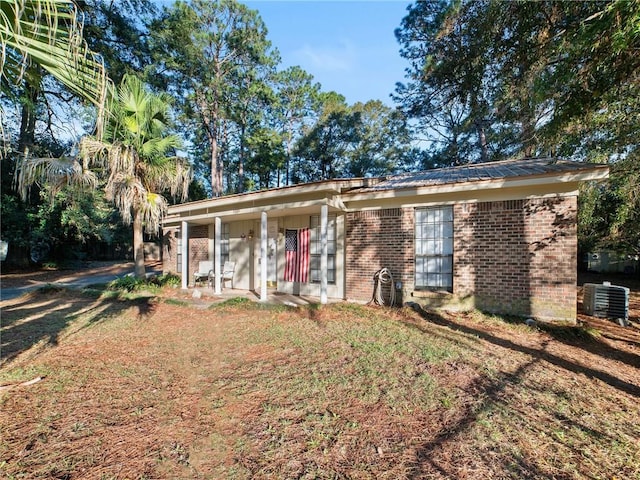 ranch-style house with a front yard, a porch, and central AC