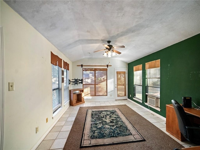 interior space featuring light tile patterned floors, lofted ceiling, a textured ceiling, and a wealth of natural light