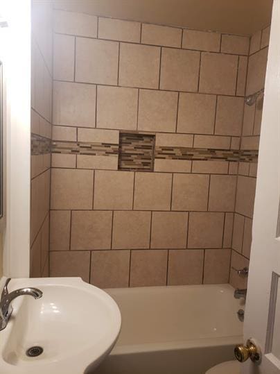 bathroom featuring shower / bathtub combination and a sink