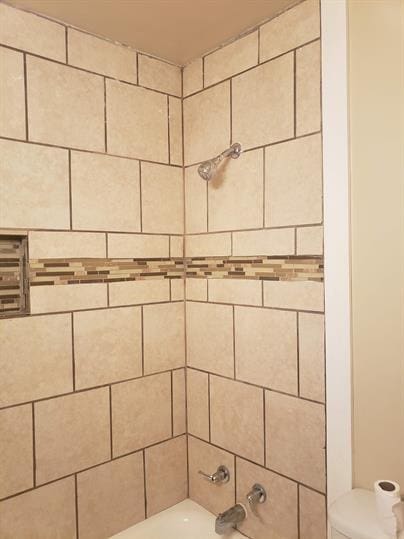 interior details with tub / shower combination and toilet