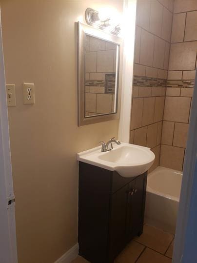 bathroom with shower / bath combination, tile patterned flooring, baseboards, and vanity