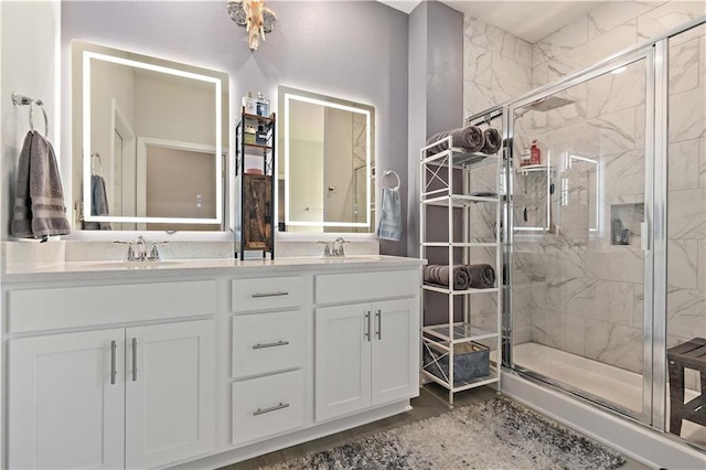 bathroom with vanity and a shower with door