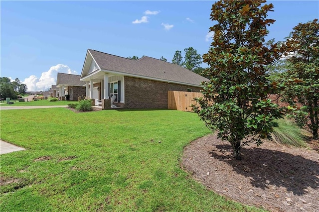 view of side of property featuring a yard