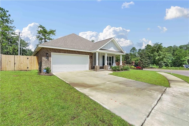 craftsman-style house featuring a garage, covered porch, and a front lawn