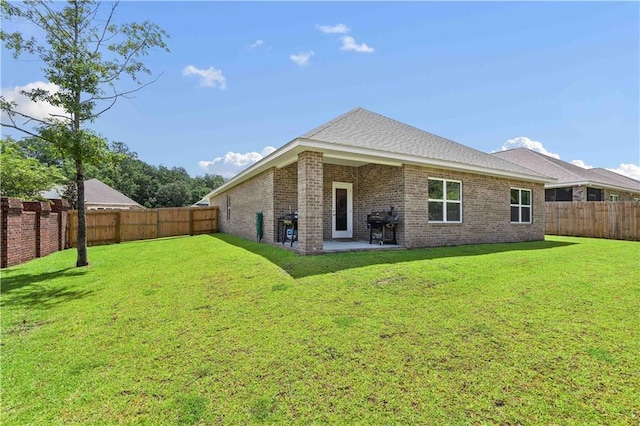 back of property featuring a patio and a yard