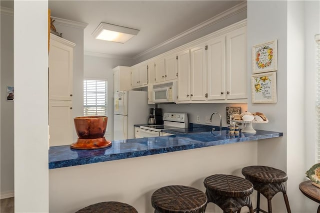 50 Forney Johnston Dr Unit 7A, Dauphin Island, AL 36528 - kitchen with white appliances, dark countertops, ornamental molding, and white cabinets