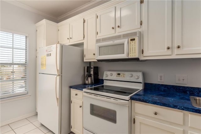 50 Forney Johnston Dr Unit 7A, Dauphin Island, AL 36528 - kitchen with white appliances, light tile patterned floors, dark countertops, white cabinetry, and crown molding