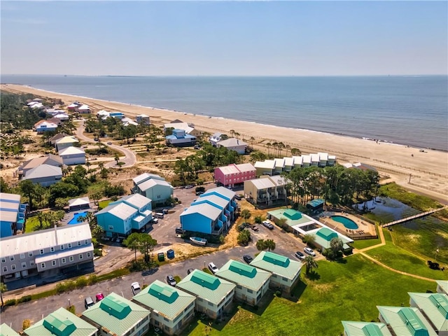 drone / aerial view featuring a view of the beach and a water view