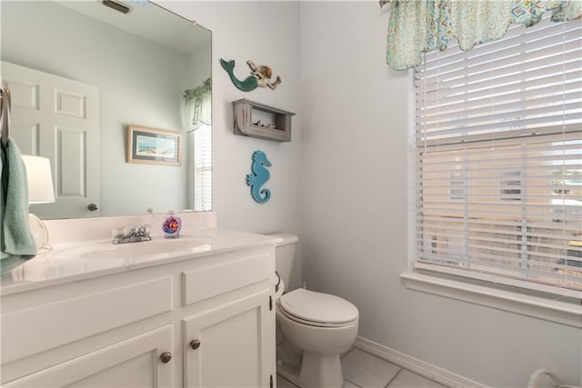 50 Forney Johnston Dr Unit 7A, Dauphin Island, AL 36528 - bathroom with tile patterned flooring, toilet, vanity, and a healthy amount of sunlight