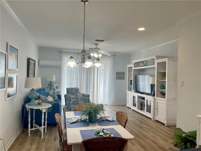 50 Forney Johnston Dr Unit 7A, Dauphin Island, AL 36528 - dining area with a wall unit AC, a notable chandelier, wood finished floors, and ornamental molding