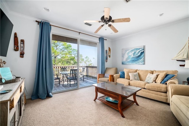 living room with ceiling fan, crown molding, and carpet flooring