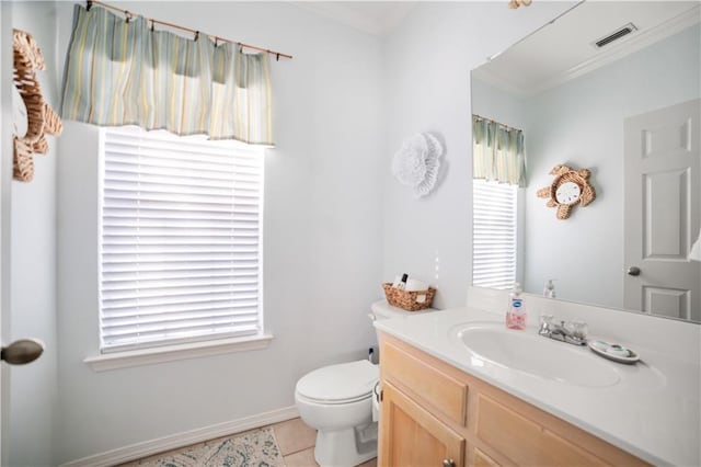 bathroom featuring toilet, vanity, tile patterned floors, and ornamental molding