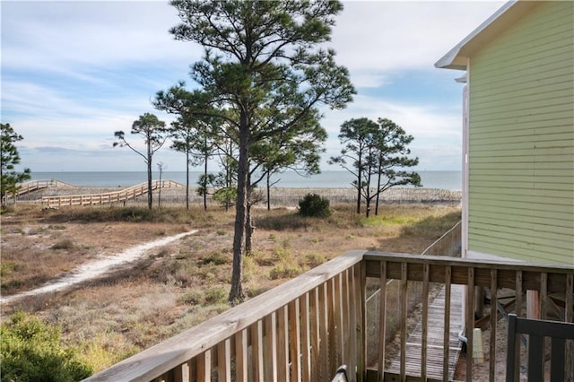 wooden terrace featuring a water view