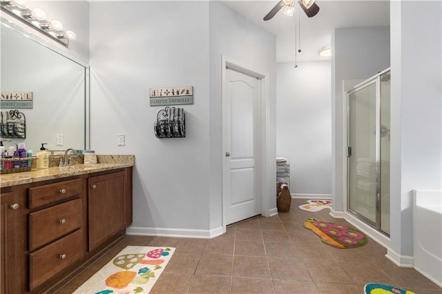 bathroom featuring vanity, independent shower and bath, ceiling fan, and tile patterned floors