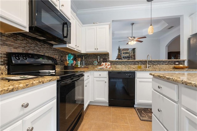 kitchen with white cabinets, ornamental molding, light tile patterned floors, black appliances, and light stone countertops