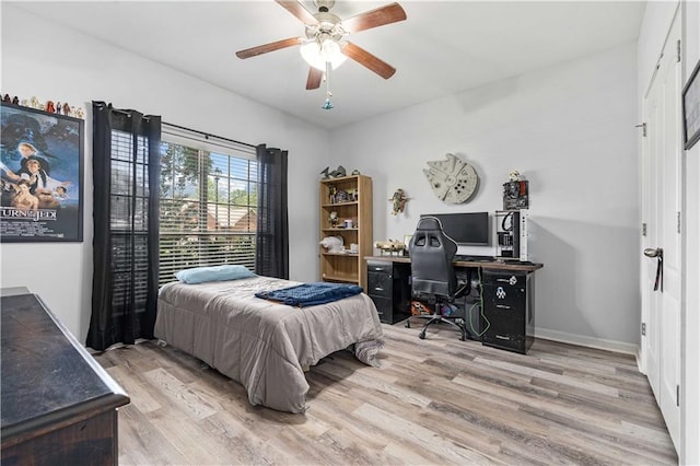 bedroom with light hardwood / wood-style flooring and ceiling fan